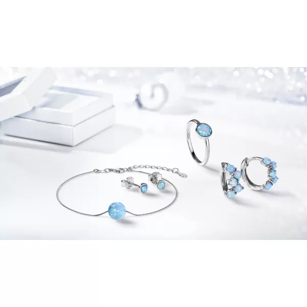 Stříbrné náušnice pecky se syntetickým opálem světle modré kulaté 11338.3