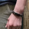 Pánský náramek s pravými lávovými kameny a koženkovým zapleteným páskem 43022.3 černý 22cm